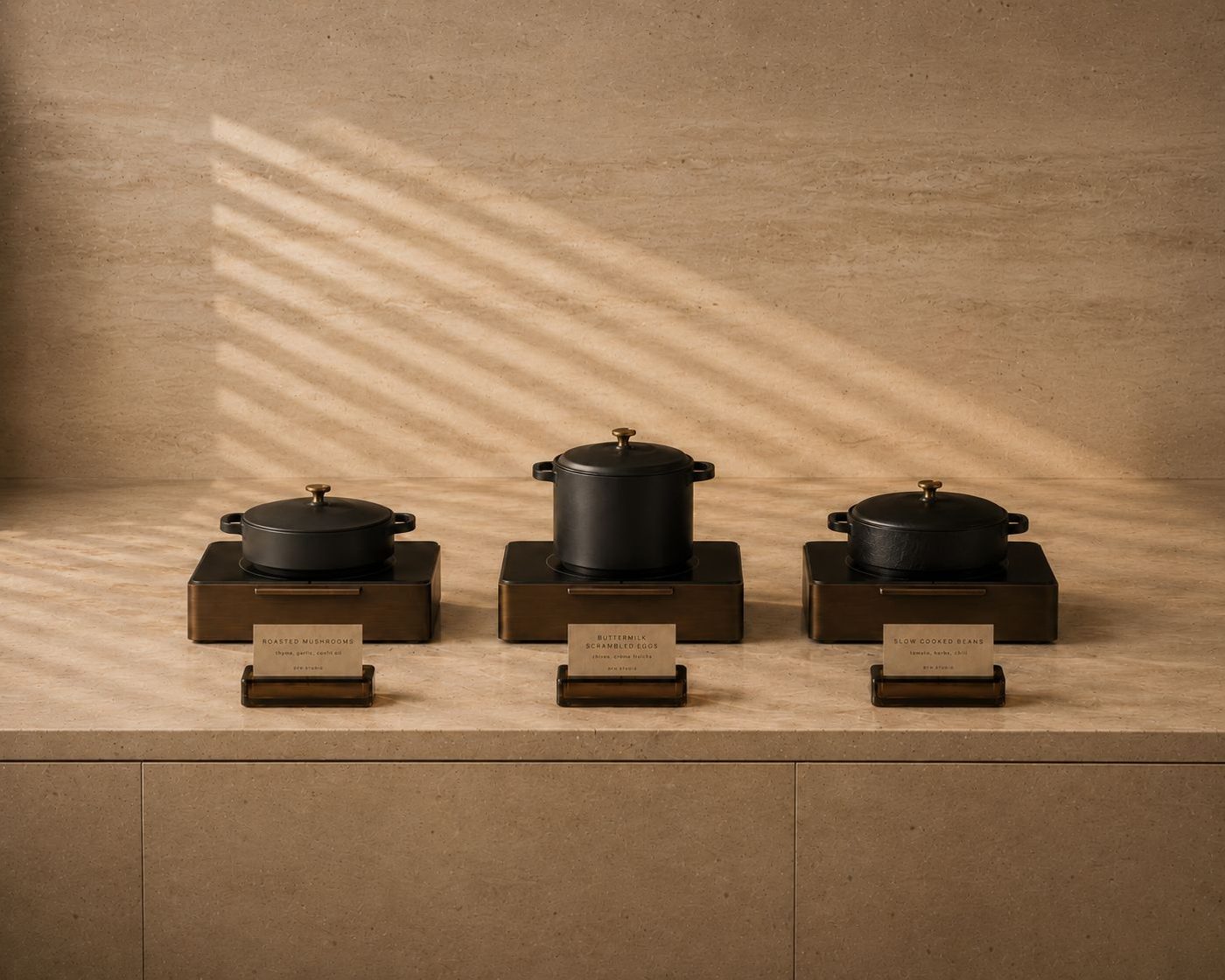 Three cast-iron pots on cordless induction units with card holders